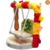 Ornate wooden Ladoo Gopal Jhula with red and yellow floral accents from Vrindavan Puja Store.